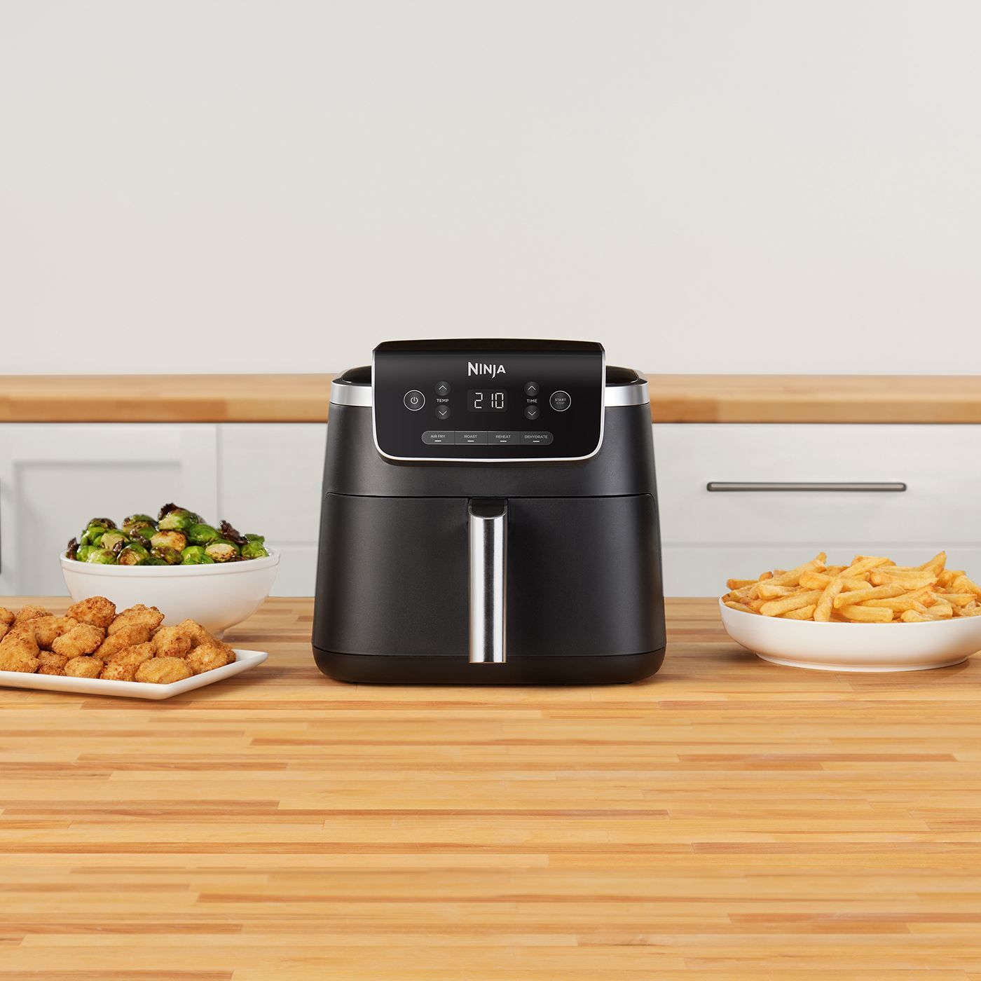 Ninja-AF140UK-InUse-Kitchen-OnIsland-Chicken-Nuggs-Fries-Brussels